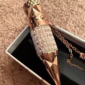 Light red lipstick very bougie rose gold case w pearls and rhinestones & chain